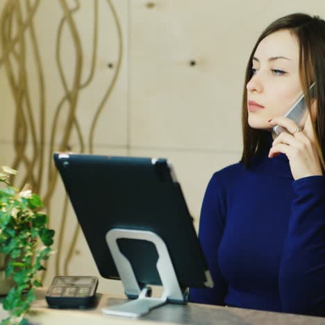 Young-administrator-speaks-on-the-phone-with-the-client-and-takes-orders-1