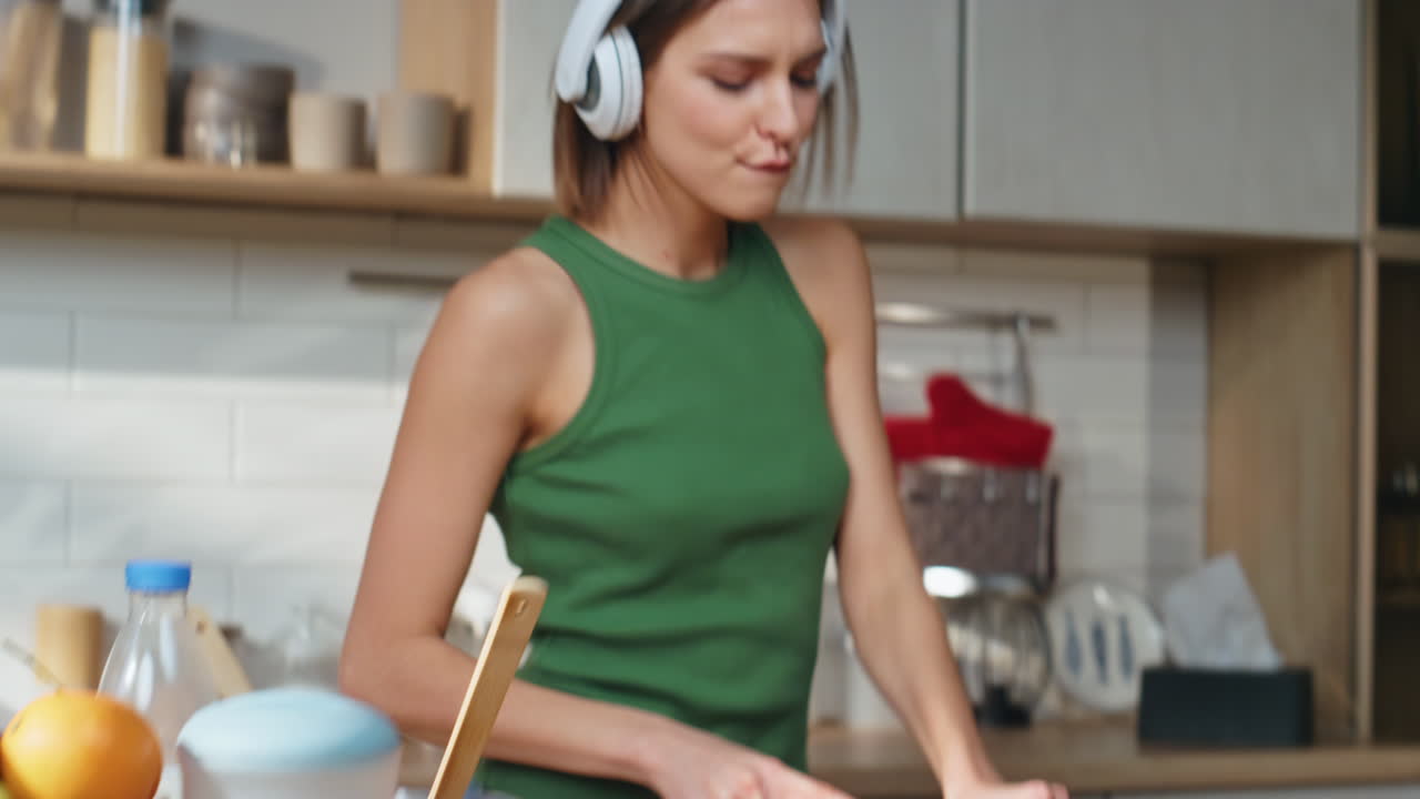 Woman Cooking and Dancing in the Kitchen