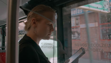 woman reading an e-book on a bus in barcelona