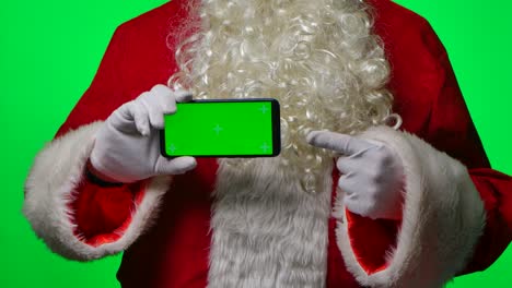 santa claus holding a smartphone with green screen