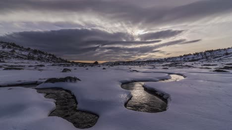 time lapse of some clouds over snowy valley