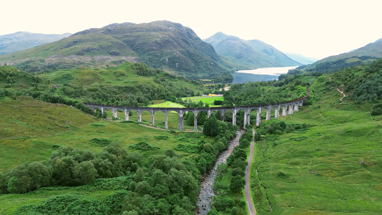 Establishing drone shot of Glenfinnan Viaduct and Loch Shiel during the day at Glenfinnan, in the Lochaber district of north-western Scotland, UK