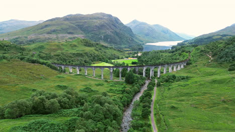 establishing drone shot of glenfinnan viaduct and loch shiel during the day at glenfinnan, in the lochaber district of north-western scotland, uk