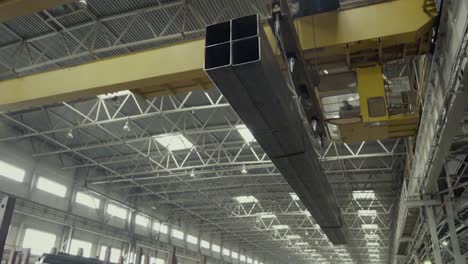 metal beams being transported in a factory