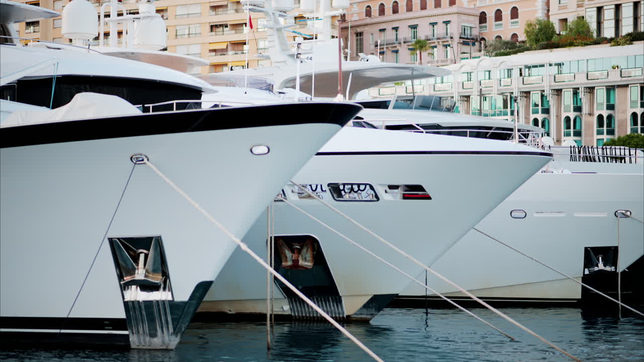 La Condamine, Monaco - October 4, 2024: View of boats docked in the Monaco Marina with the skyline of the city on the background