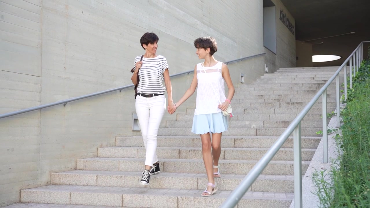 A young couple delightfully enjoying a leisurely stroll down the stairs in modern architecture
