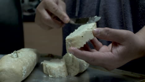 spreading garlic butter on cut bread pieces