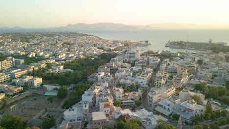 Aerial-View-of-Whitewashed-Buildings-in-Kos-Harbor-Town,-Greece