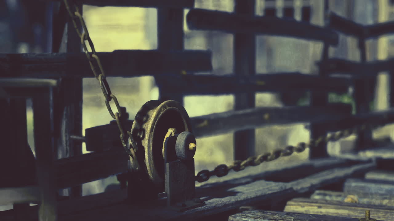 Rusty pulley system in an old wooden framework at an abandoned location