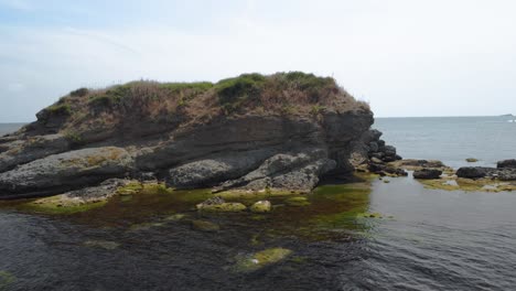 Drone-arc-footage-around-small-island-in-Black-sea,-Bulgaria-3