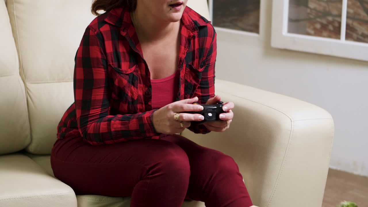 mujer jugando videojuegos en el sofá