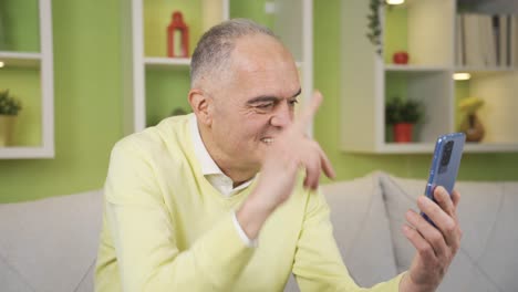 Grandfather-is-video-chatting-with-his-grandchildren-at-home.