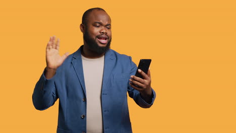 Upbeat-man-having-friendly-conversation-with-friends-during-videocall