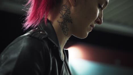 emo red punk woman in black jacket with neck tattoo