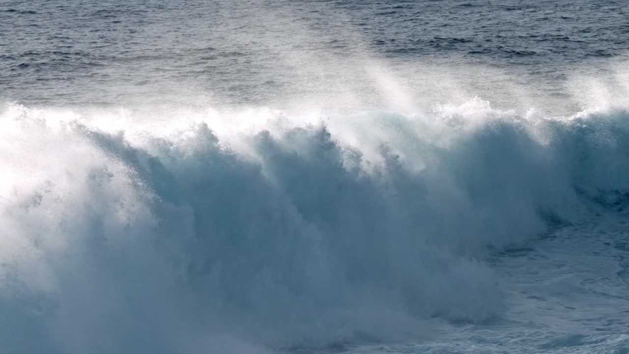 Dramatic ocean waves collide with the volcanic coastline near Timanfaya National Park, located on the island of Lanzarote in the Canary Islands, Spain.