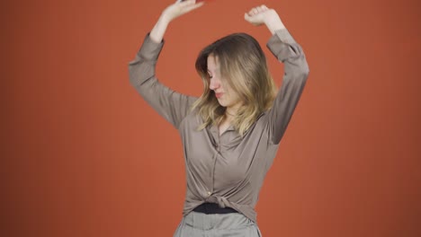 Dancing-young-woman-with-phone-in-hand.