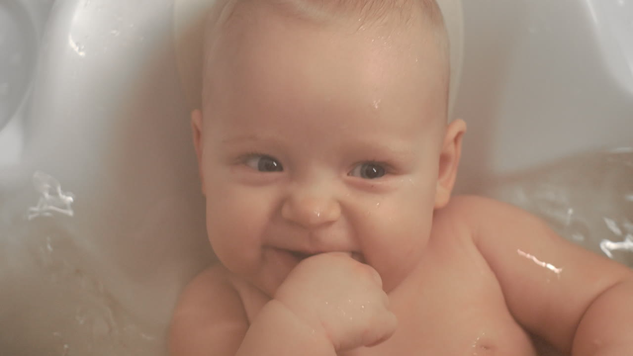 Close-up de uma bebê adorável sorrindo na banheira.