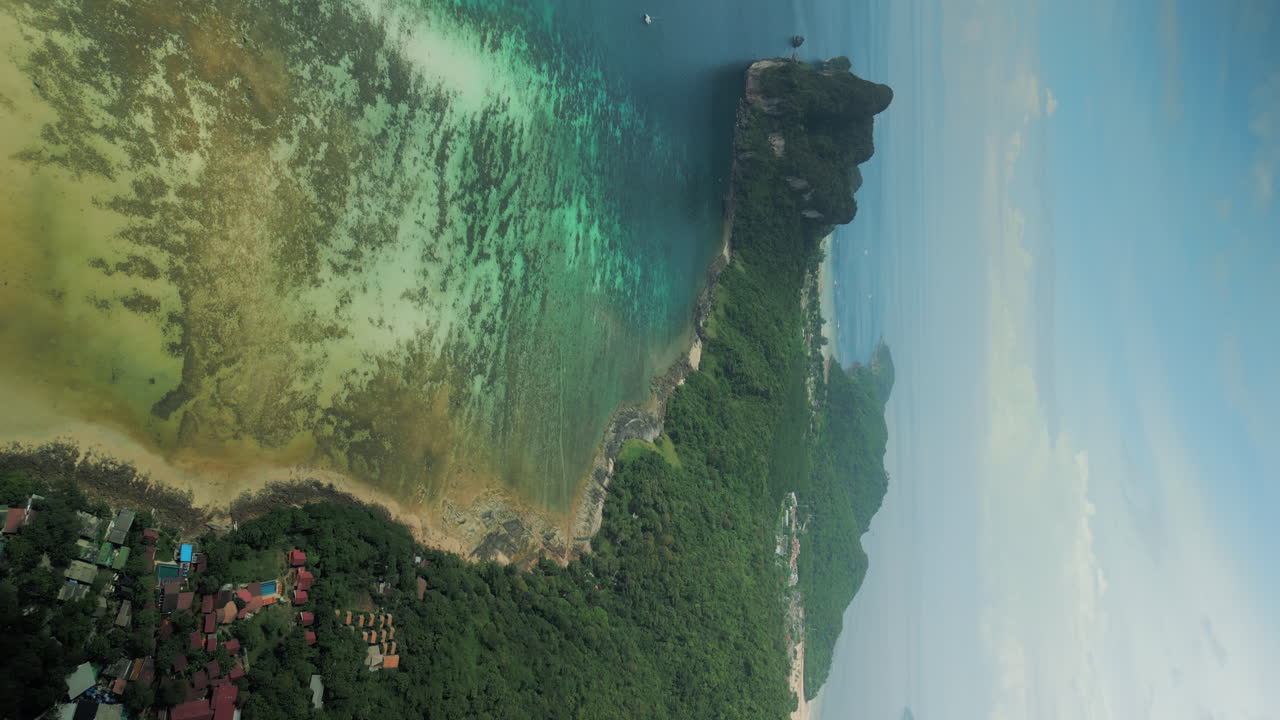 Aerial View of Tropical Island Coastline with Clear Turquoise Waters and Reef