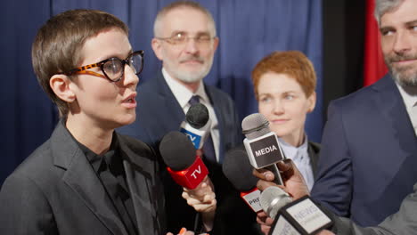reporters interviewing female politician