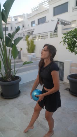 woman practicing ball exercise outdoors
