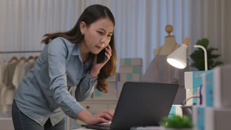 asian owner woman serious work at night in home office.