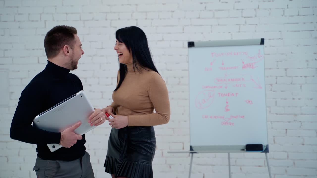 Young business couple. Young caucasian business couple laughs happily