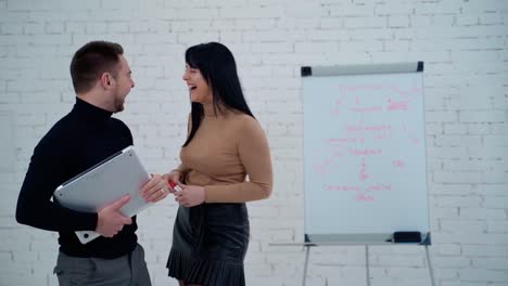 young business couple. young caucasian business couple laughs happily