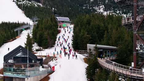 large group of skiers and snowboarders go downhill on dolni morava skiing resort