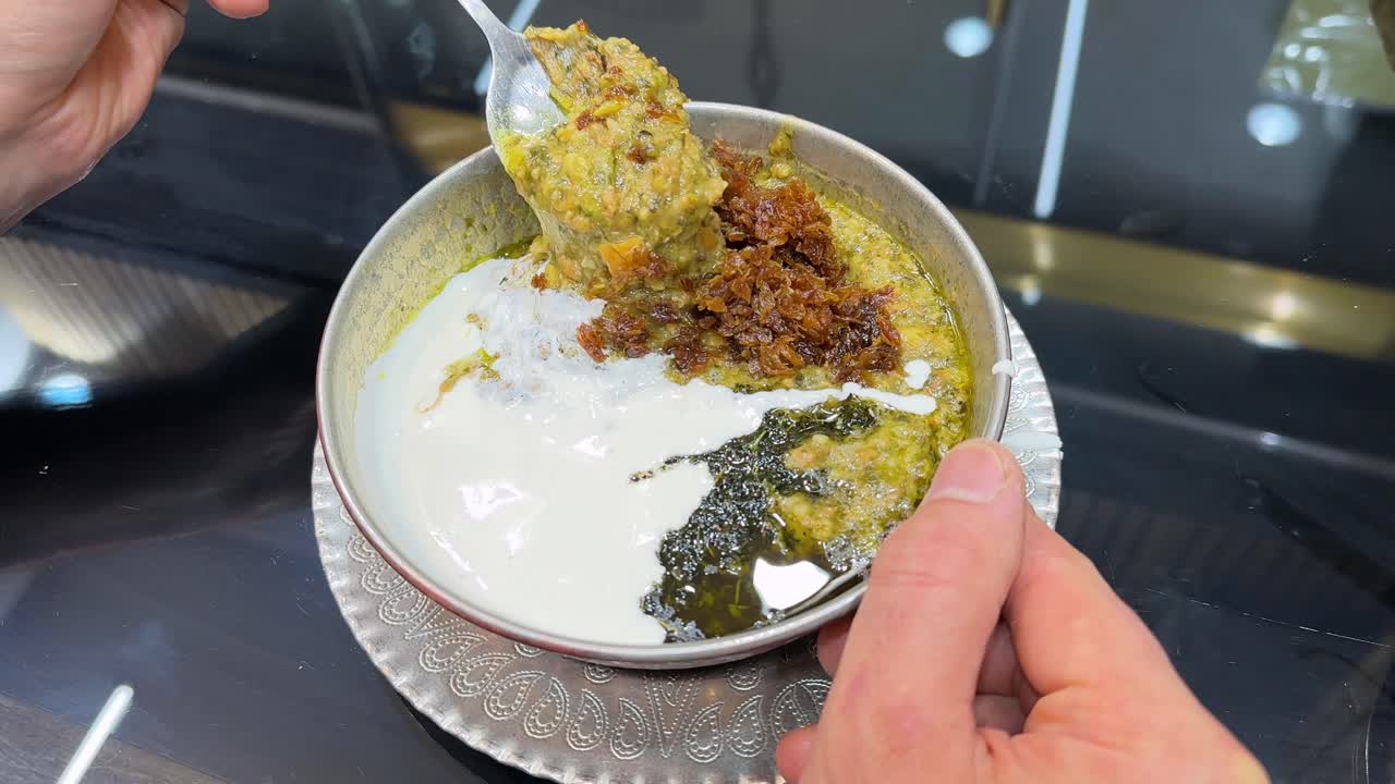 Traditional Iranian food delicious ash stew haleem garnished with fried garlic and mint kashk is a healthy lentil soup nutritious meal halal dish Ramadan Iftar dinner Tehran Middle Eastern gastronomy