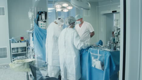 surgical team operates patient in clinic. skilled medics in sterile uniform engage in complicated coronary artery bypass graft surgery in hospital