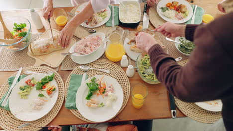 above, table and family with food in home