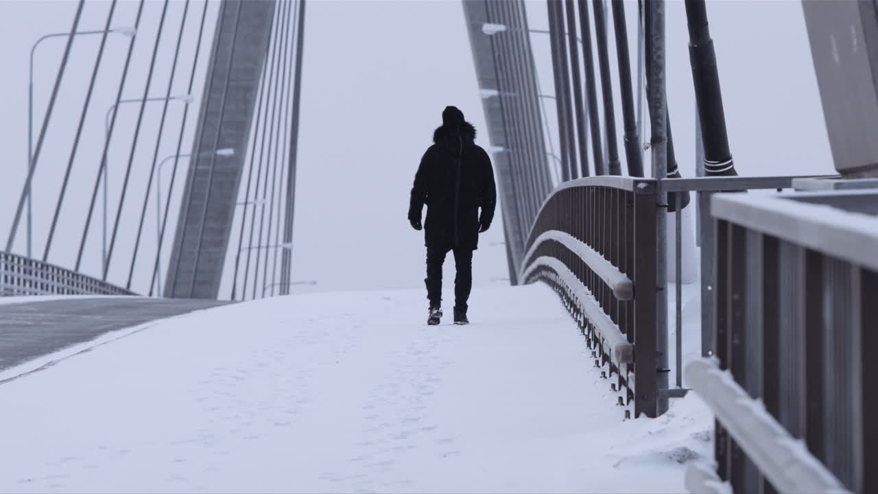 Dark man under the snow walking away from the camera on the Replot ...