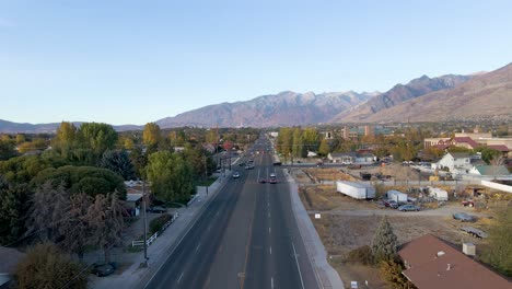 Pleasant-Grove-residential-city-streets-in-Utah,-mountain-backdrop,-aerial-view