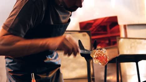 glassblower shaping a molten glass