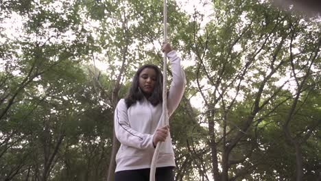 a sporty gymnast performs exercises with a rope in sportswear