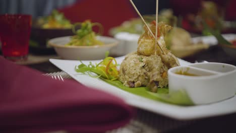 Asian-food-fried-rice-with-fried-chicken-on-skewers,-spicey-food,-Asian-dinner,-Asian-table-setup