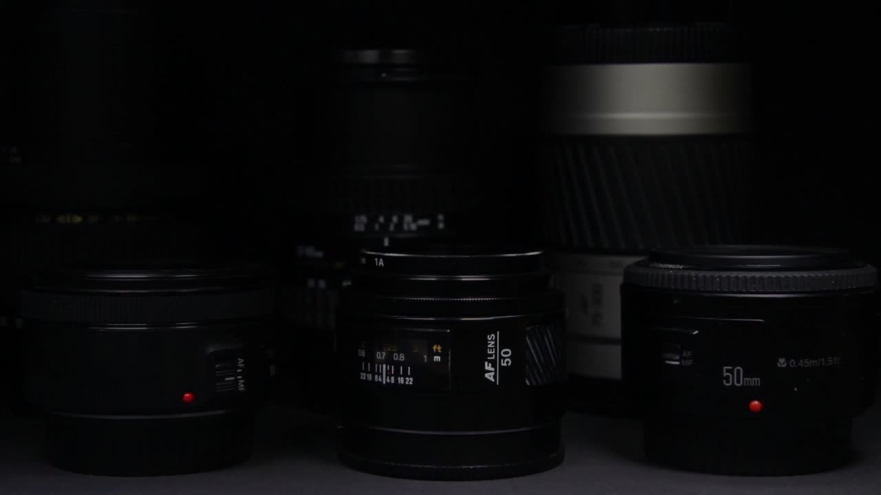 The light moves slowly over the camera lenses without visible brands on a black dark background