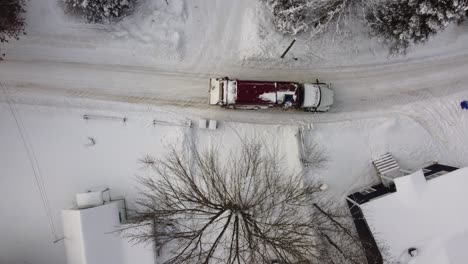 garbage truck collecting waste in a residential area covered in snow in sherbrooke, canada, during the winter season