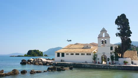 airplane lands at corfu greece, view from panagia vlahernon and pontikonisi, close to land flying airship, real time shot