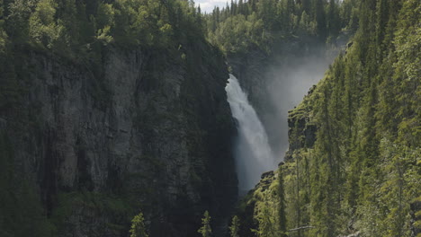 Hallingsafallet-waterfall-gushing-from-the-top-of-the-rocky-canyon-in-the-summer