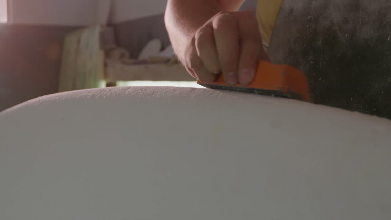 Male surfboard maker in his workshop