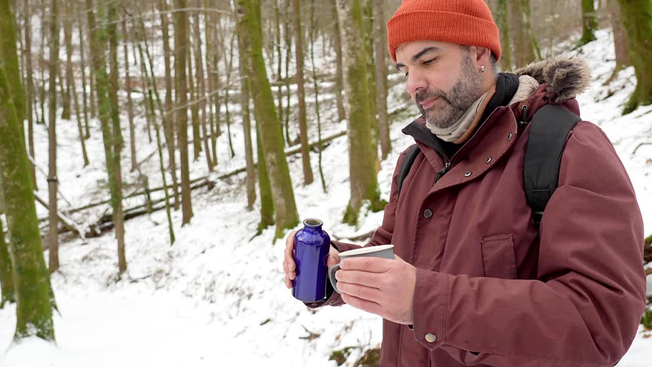 Man Pouring Drink in Winter Woods