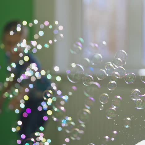 energetic boy catching bubbles