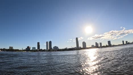 time-lapse of sunset behind urban skyline over water