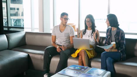 Business-colleagues-discussing-over-laptop-4k