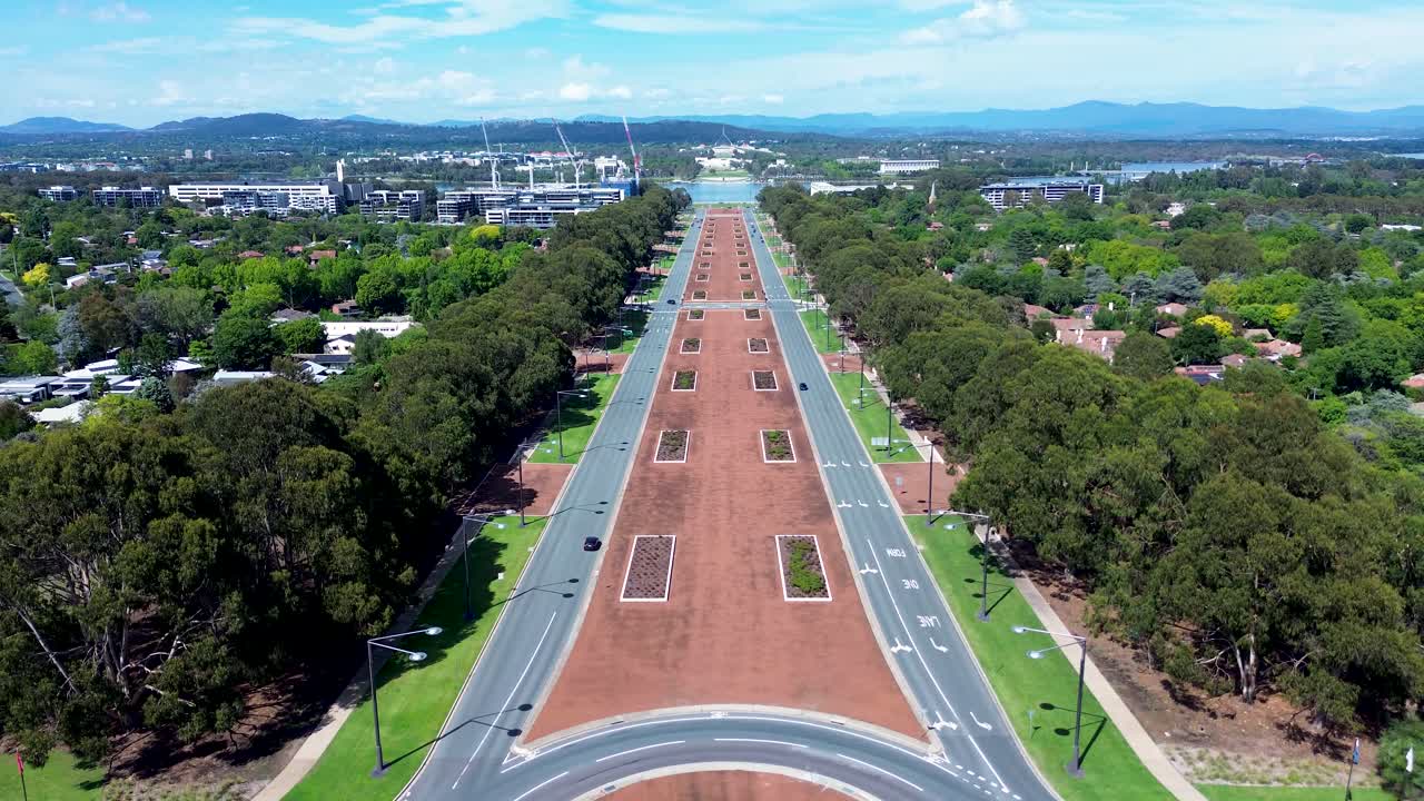 Drone aerial landscape of car vehicles traffic driving around roundabout with streetlights at urban intersection Anzac Parade road street boulevard Canberra ACT Australia tourism city travel