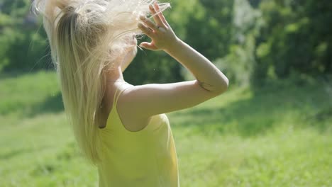 woman in yellow dress dancing gracefully in summer park