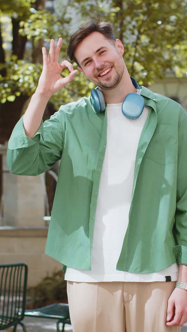 백인 남자가 카메라를 쳐다보며 승인합니다. ok 제스처 긍정적입니다. ok 기호와 같이 축하합니다. 승리합니다.