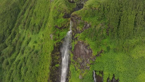 magical powerfull poço ribeira do ferreiro waterfall at azores - drone shot