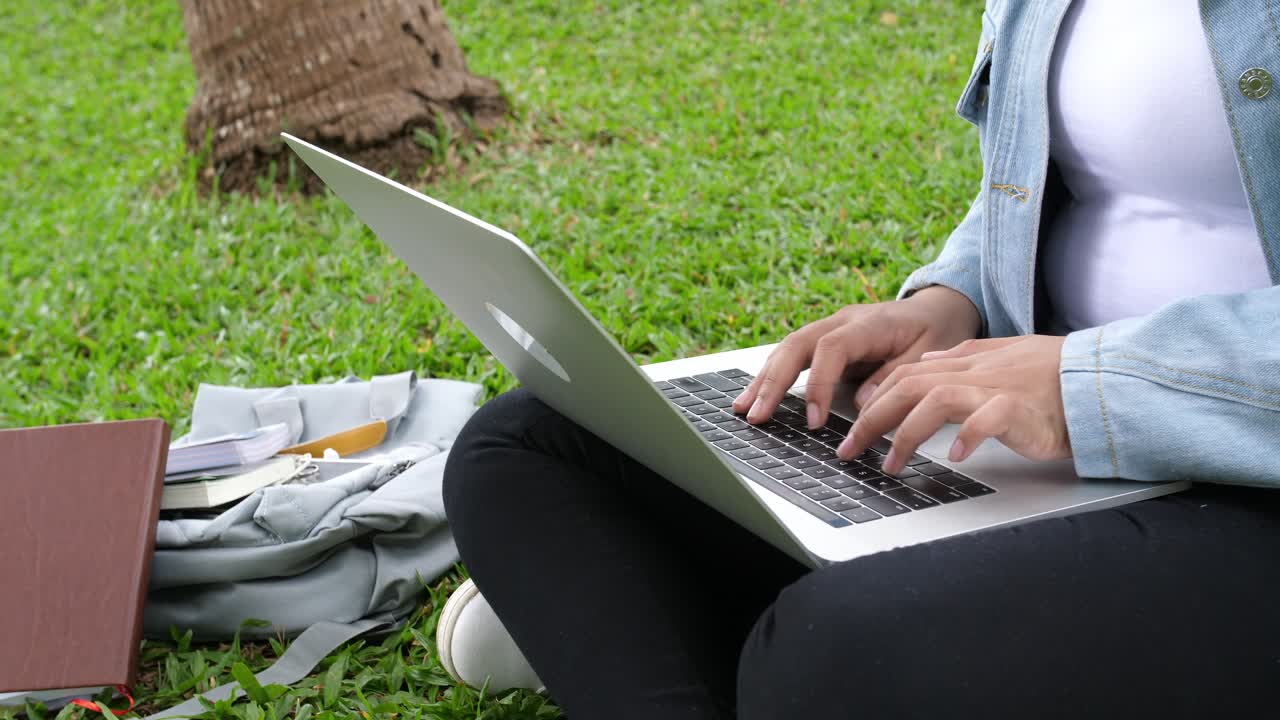 Woman Sitting In Park And Using Laptop, Video In 4K